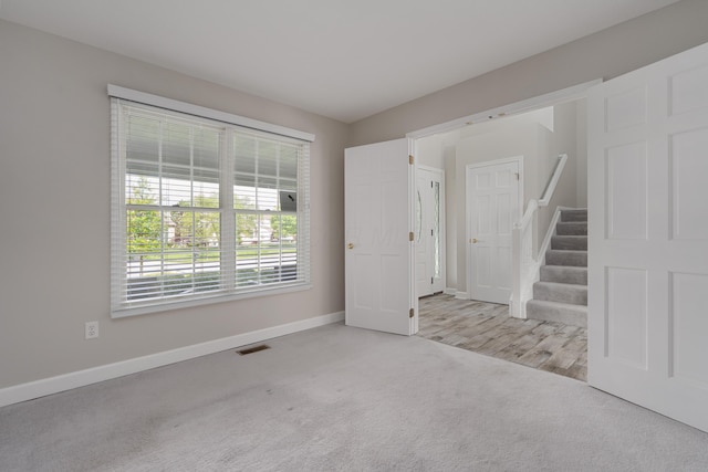 4526 Hoffman Farms Dr, Hilliard, OH 43026 - empty room with baseboards, carpet flooring, and stairs