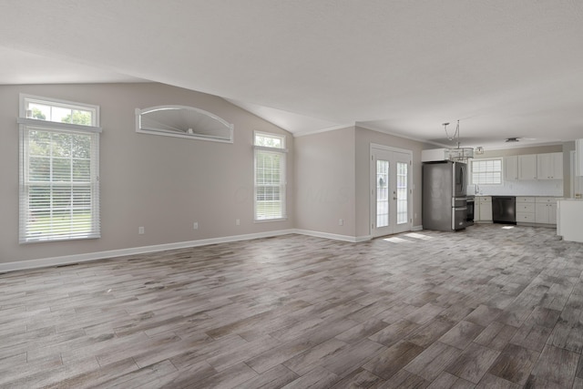4526 Hoffman Farms Dr, Hilliard, OH 43026 - unfurnished living room featuring light wood-style flooring, baseboards, and vaulted ceiling