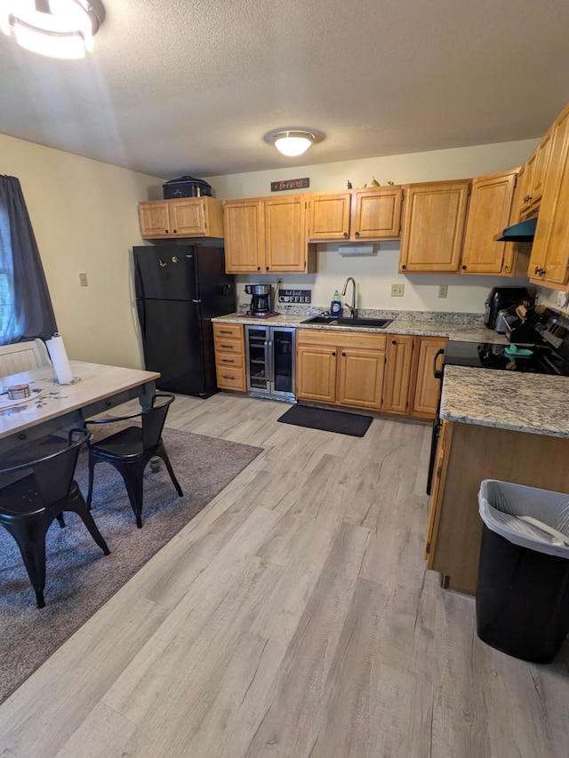 4280 Township Road 230, Cardington, OH 43315 - kitchen featuring a sink, freestanding refrigerator, light wood-type flooring, under cabinet range hood, and beverage cooler