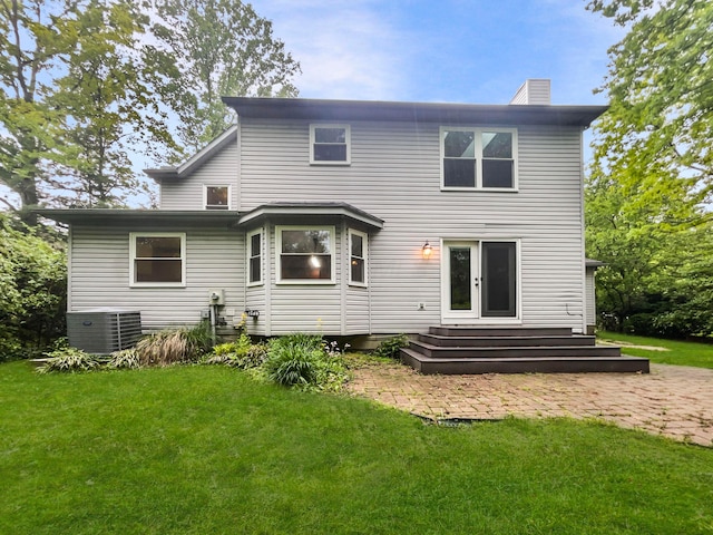 642 Ridenour Rd, Columbus, OH 43230 - back of property featuring cooling unit, a chimney, a yard, and a patio