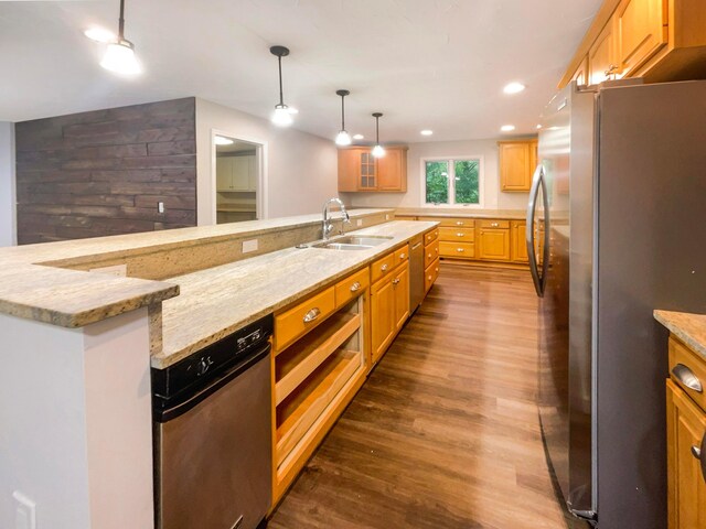 642 Ridenour Rd, Columbus, OH 43230 - kitchen featuring freestanding refrigerator, a sink, dark wood-style flooring, light stone counters, and hanging light fixtures