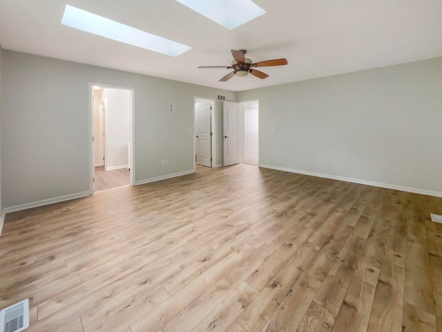 642 Ridenour Rd, Columbus, OH 43230 - empty room featuring a skylight, light wood finished floors, baseboards, and ceiling fan