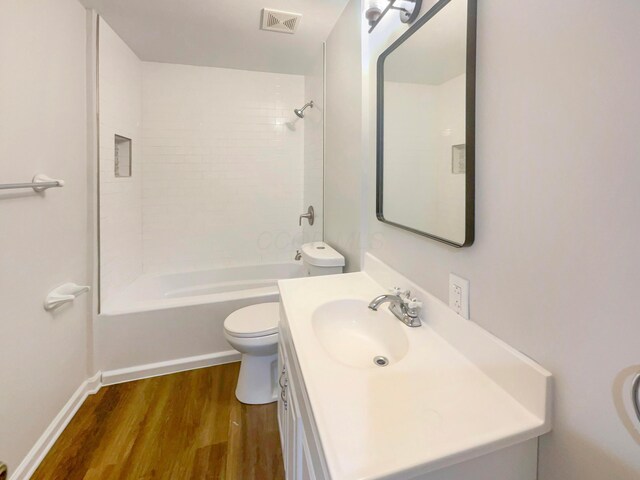 642 Ridenour Rd, Columbus, OH 43230 - bathroom featuring toilet, wood finished floors, vanity,  shower combination, and baseboards