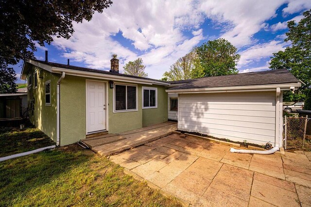795 Brixham Rd, Columbus, OH 43204 - rear view of property with a patio, stucco siding, and a chimney
