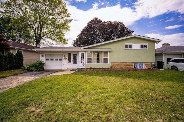 795 Brixham Rd, Columbus, OH 43204 - view of front of house with an attached garage, asphalt driveway, a front lawn, and stucco siding