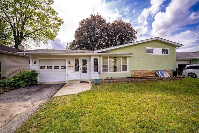 795 Brixham Rd, Columbus, OH 43204 - view of front of property featuring an attached garage, driveway, a front yard, and stucco siding