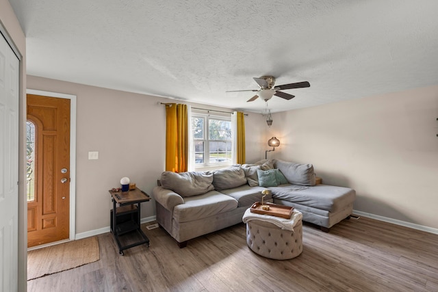 2267 Anndel Ct, Grove City, OH 43123 - living area featuring a ceiling fan, wood finished floors, baseboards, and a textured ceiling
