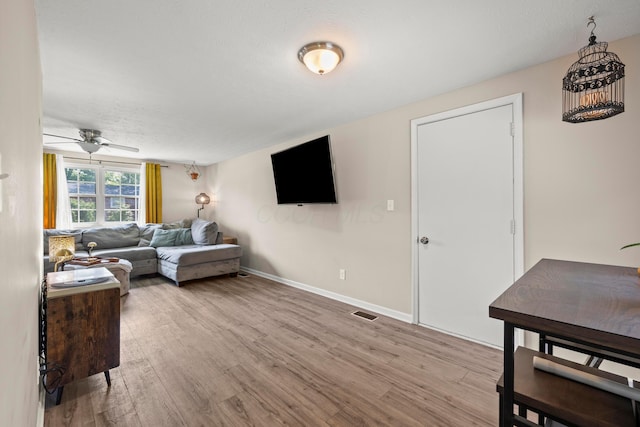 2267 Anndel Ct, Grove City, OH 43123 - living area featuring light wood-type flooring, a ceiling fan, and baseboards