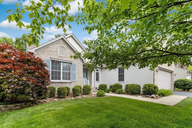1275 Shelby Cir, Reynoldsburg, OH 43068 - view of front of home featuring a front yard, an attached garage, brick siding, and concrete driveway