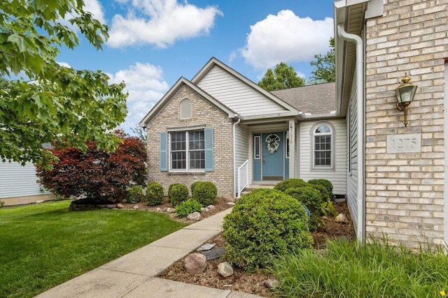 1275 Shelby Cir, Reynoldsburg, OH 43068 - view of front of property featuring brick siding, a front yard, and a shingled roof