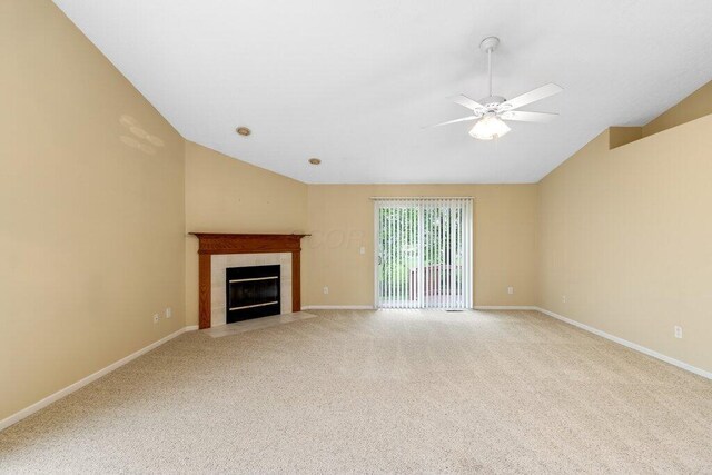 1275 Shelby Cir, Reynoldsburg, OH 43068 - unfurnished living room with lofted ceiling, light colored carpet, a tiled fireplace, a ceiling fan, and baseboards