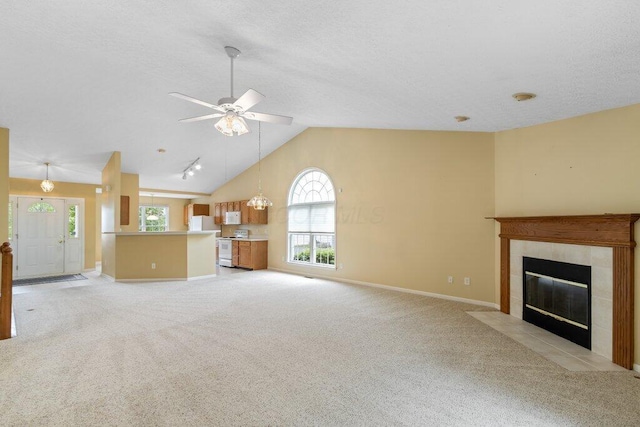 1275 Shelby Cir, Reynoldsburg, OH 43068 - unfurnished living room with vaulted ceiling, healthy amount of natural light, light carpet, and a textured ceiling