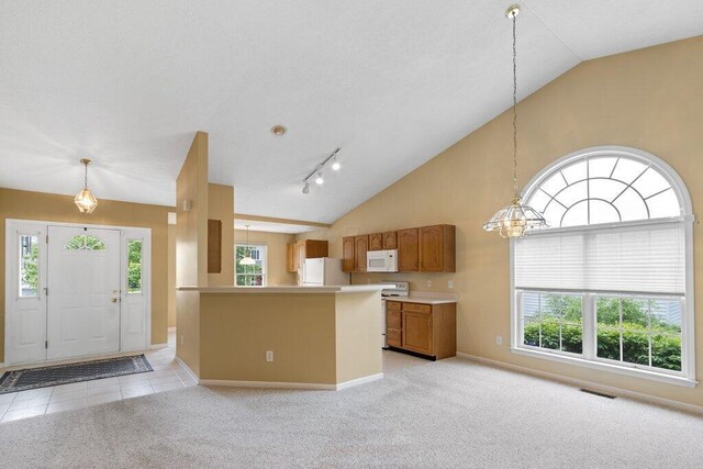 1275 Shelby Cir, Reynoldsburg, OH 43068 - kitchen with white appliances, brown cabinetry, hanging light fixtures, baseboards, and high vaulted ceiling