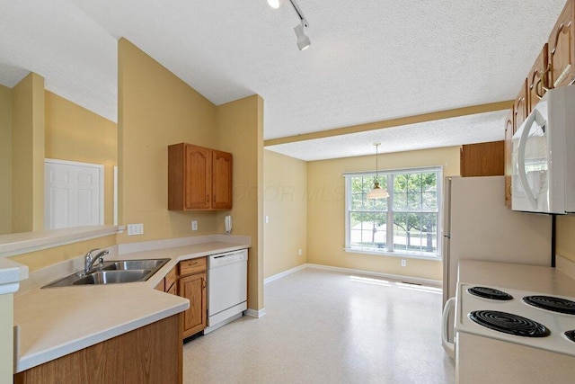 1275 Shelby Cir, Reynoldsburg, OH 43068 - kitchen featuring white appliances, a sink, light floors, baseboards, and rail lighting