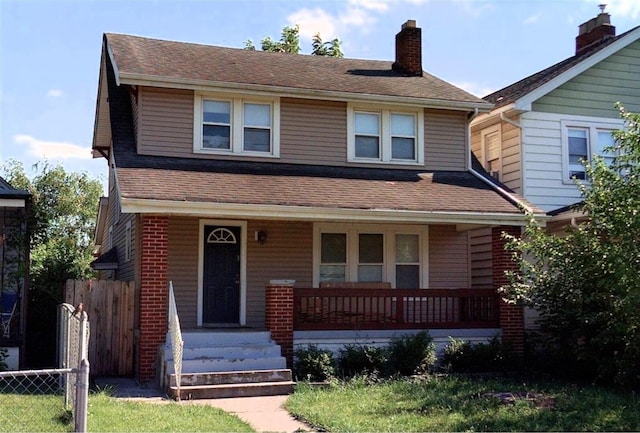 799 E Deshler Ave, Columbus, OH 43206 - view of front facade with a porch, roof with shingles, and a chimney