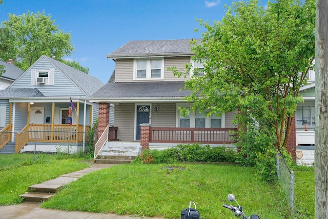 799 E Deshler Ave, Columbus, OH 43206 - view of front of property with a porch, a shingled roof, and a front lawn