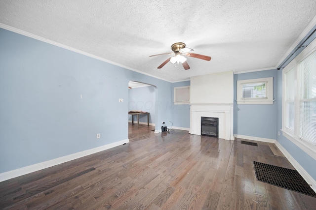 799 E Deshler Ave, Columbus, OH 43206 - unfurnished living room featuring a ceiling fan, a fireplace, arched walkways, wood finished floors, and a textured ceiling