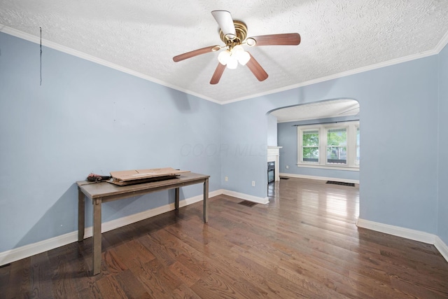 799 E Deshler Ave, Columbus, OH 43206 - spare room with wood finished floors, a textured ceiling, ceiling fan, arched walkways, and a glass covered fireplace