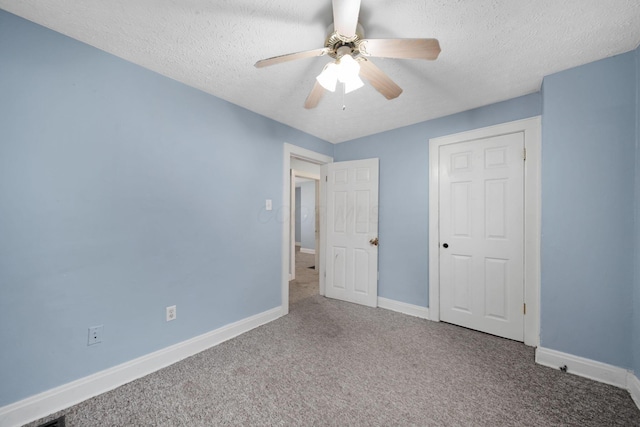 799 E Deshler Ave, Columbus, OH 43206 - unfurnished bedroom featuring carpet, a textured ceiling, baseboards, and a ceiling fan