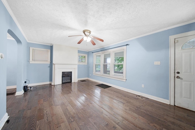 799 E Deshler Ave, Columbus, OH 43206 - unfurnished living room with ceiling fan, arched walkways, wood finished floors, a fireplace, and ornamental molding