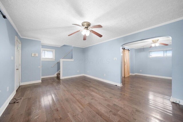 799 E Deshler Ave, Columbus, OH 43206 - unfurnished living room with ceiling fan, a barn door, stairway, wood finished floors, and a textured ceiling