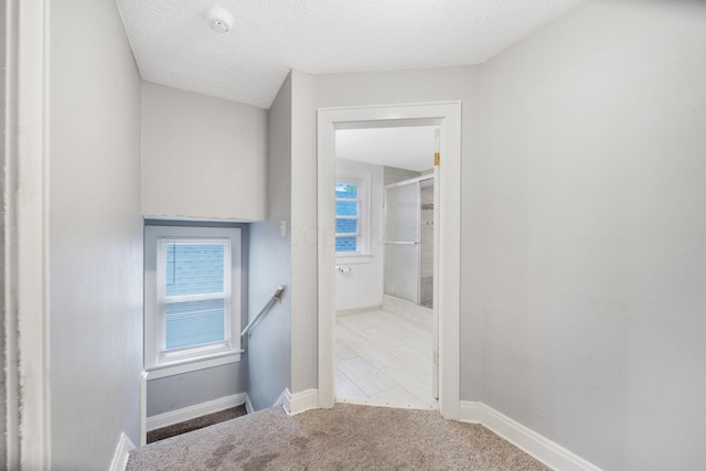 799 E Deshler Ave, Columbus, OH 43206 - hall featuring an upstairs landing, baseboards, carpet floors, and a textured ceiling