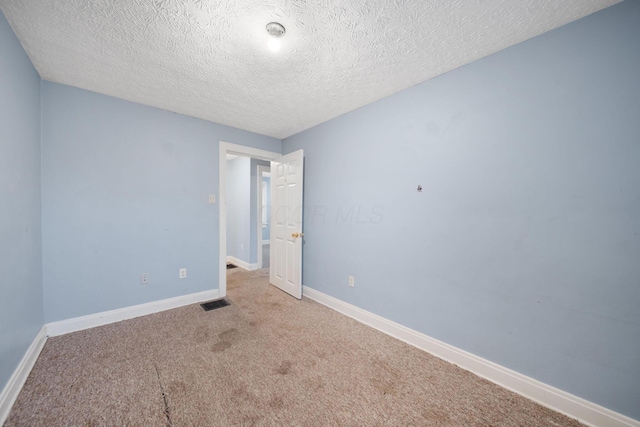 799 E Deshler Ave, Columbus, OH 43206 - carpeted spare room with a textured ceiling and baseboards