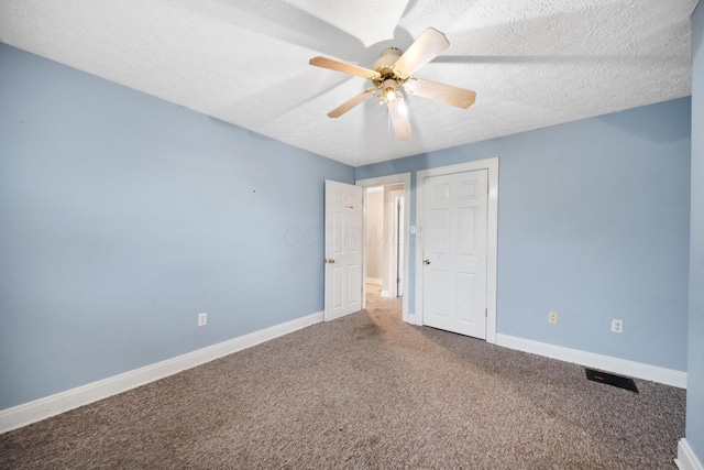 799 E Deshler Ave, Columbus, OH 43206 - unfurnished bedroom with carpet floors, baseboards, a textured ceiling, and ceiling fan