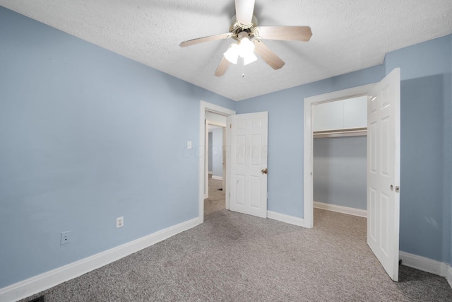 799 E Deshler Ave, Columbus, OH 43206 - unfurnished bedroom featuring carpet floors, a textured ceiling, baseboards, a ceiling fan, and a closet