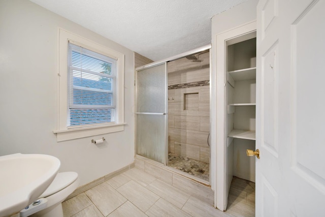 799 E Deshler Ave, Columbus, OH 43206 - bathroom with a stall shower, baseboards, toilet, tile patterned flooring, and a sink