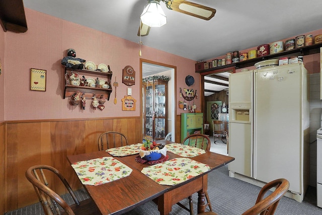 1236 8th Ave, Lancaster, OH 43130 - dining space with a ceiling fan, wainscoting, carpet floors, and wood walls