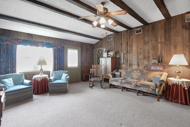 1236 8th Ave, Lancaster, OH 43130 - living room featuring wood walls, carpet, a ceiling fan, and a textured ceiling