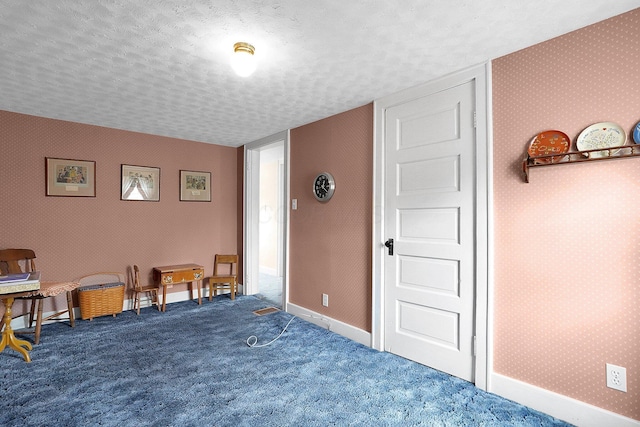 1236 8th Ave, Lancaster, OH 43130 - living area featuring a textured ceiling, wallpapered walls, carpet flooring, and baseboards
