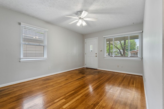 471 Chase Rd, Columbus, OH 43214 - empty room with wood finished floors, a textured ceiling, a ceiling fan, and baseboards
