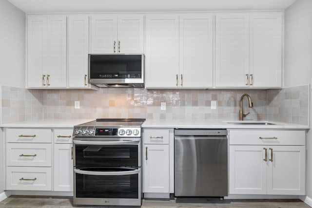 471 Chase Rd, Columbus, OH 43214 - kitchen with stainless steel appliances, a sink, light countertops, and white cabinets