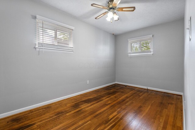 471 Chase Rd, Columbus, OH 43214 - empty room with dark wood-style flooring, baseboards, ceiling fan, and a textured ceiling