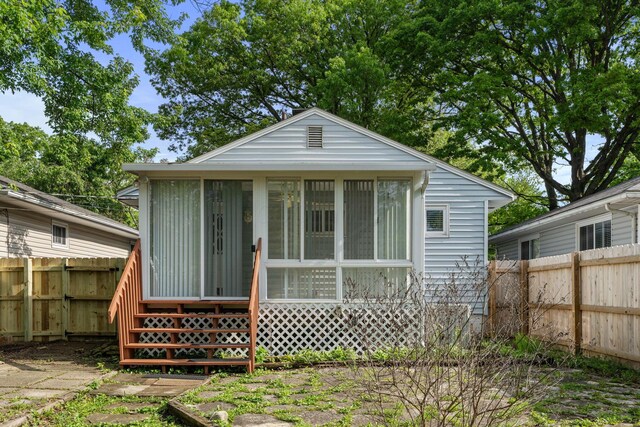 471 Chase Rd, Columbus, OH 43214 - back of house featuring a sunroom, a fenced backyard, and entry steps