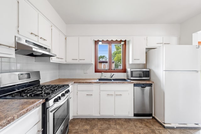 5707 Lindenwood Rd, Columbus, OH 43229 - kitchen featuring under cabinet range hood, appliances with stainless steel finishes, a sink, and white cabinets