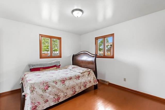 5707 Lindenwood Rd, Columbus, OH 43229 - bedroom with multiple windows, wood finished floors, and baseboards