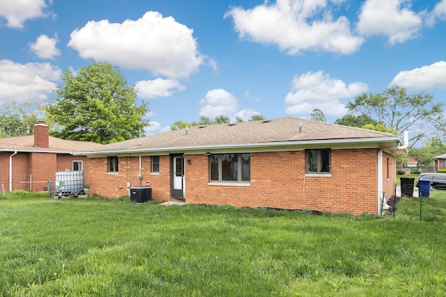 5707 Lindenwood Rd, Columbus, OH 43229 - rear view of house with brick siding, cooling unit, and roof with shingles