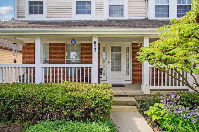 917 Linkfield Dr, Columbus, OH 43085 - property entrance featuring brick siding, covered porch, and a shingled roof