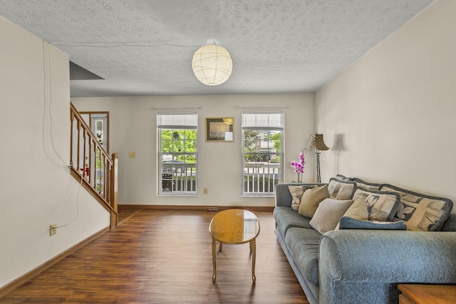 917 Linkfield Dr, Columbus, OH 43085 - living room with wood finished floors, stairway, baseboards, and a textured ceiling