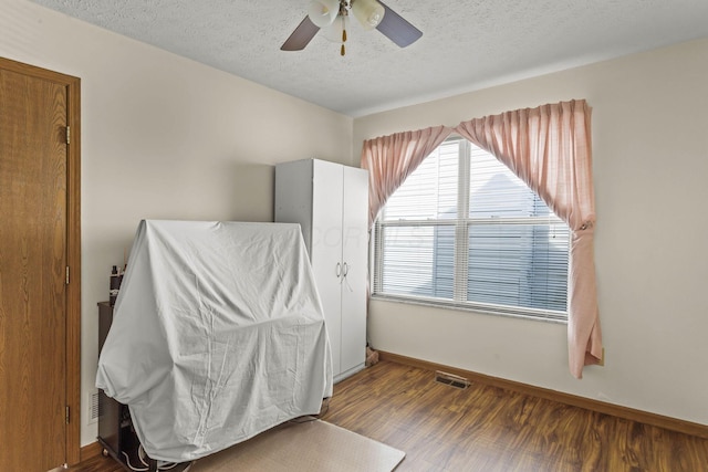 917 Linkfield Dr, Columbus, OH 43085 - unfurnished bedroom with a textured ceiling, baseboards, wood finished floors, and ceiling fan