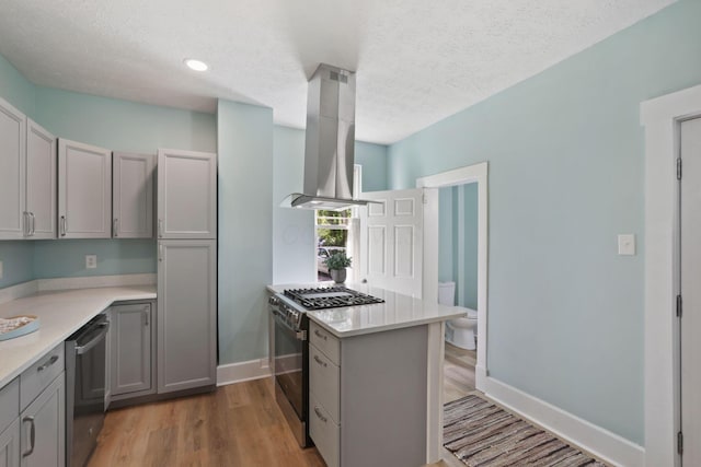 126 S Cherry St, Lancaster, OH 43130 - kitchen with stainless steel appliances, range hood, light countertops, a textured ceiling, and gray cabinets