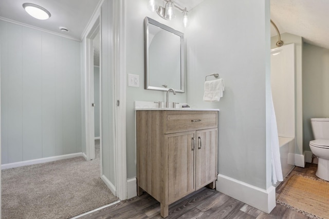126 S Cherry St, Lancaster, OH 43130 - bathroom with toilet, wood finished floors, vanity, baseboards, and crown molding