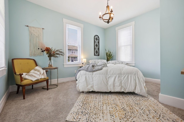 126 S Cherry St, Lancaster, OH 43130 - carpeted bedroom with a chandelier, multiple windows, and baseboards
