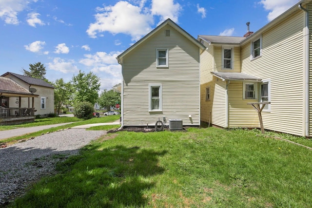 126 S Cherry St, Lancaster, OH 43130 - rear view of house featuring central AC unit and a lawn