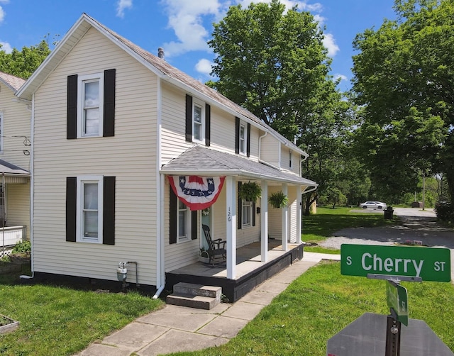 126 S Cherry St, Lancaster, OH 43130 - view of front of property with a porch, a front yard, and roof with shingles