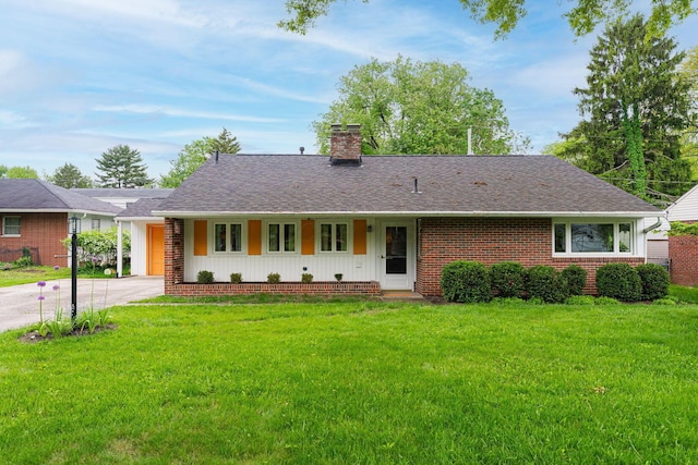 205 Meadowlark Ln, Columbus, OH 43214 - ranch-style home featuring a chimney, a front lawn, driveway, roof with shingles, and brick siding