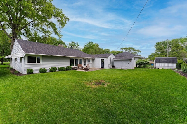 205 Meadowlark Ln, Columbus, OH 43214 - rear view of house with a patio area, a yard, an outdoor structure, a chimney, and a storage unit